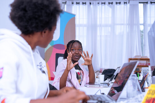 Two african girls interacting during the work time