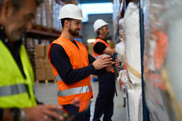 Warehouse workers scanning inventory using barcode readers