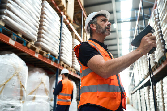 Warehouse worker scanning inventory in logistics distribution center
