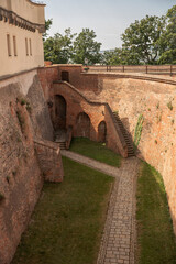 Historic brick fortress walls and cobbled walkway inside Spilberk Castle courtyard, Brno, Czech Republic. Captures medieval architecture, history, and European travel.