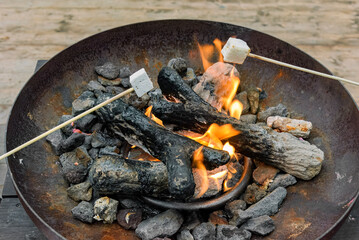 rusty fire bowl where charcoal burns and marshmallows are roasted