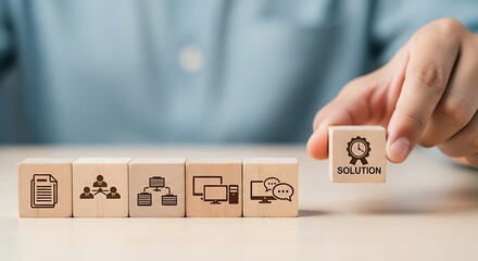 Hand placing wooden block with solution icon and text to complete business process flow chart made of icon blocks
