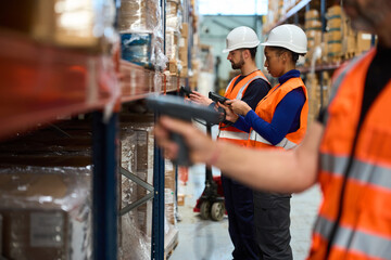 Warehouse workers scanning inventory at distribution center