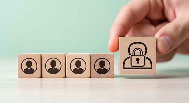 Hand placing wooden block with user profile and padlock icon next to other user blocks representing security concept