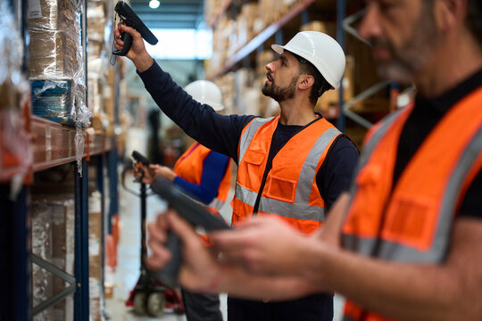 Warehouse workers scanning inventory in logistics distribution center