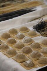 Fresh artisan ravioli handmade with traditional Italian methods, each piece filled to perfection and showcasing the rustic charm of homemade cooking.