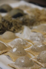 Fresh artisan ravioli handmade with traditional Italian methods, each piece filled to perfection and showcasing the rustic charm of homemade cooking.