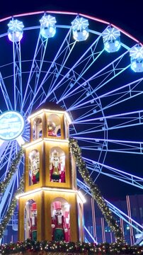 Christmas market ferris wheel with glowing nutcracker decorations