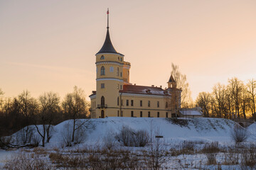 The ancient castle of Bip (Marienthal) on an orange December evening. Pavlovsk, a neighborhood of St. Petersburg. Russia