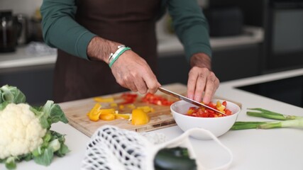 Person chopping fresh colorful vegetables for healthy meal