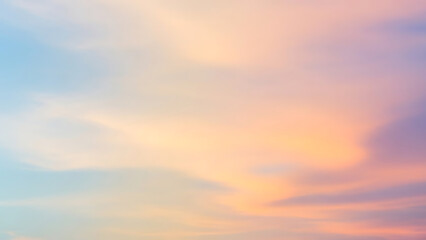 Dreamy ethereal sky background with gentle clouds painted in soft pastel colors of a tranquil sunrise or sunset