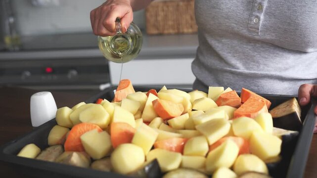 Young Woman Pours Oil And Seasons Vegetables For Oven Baking