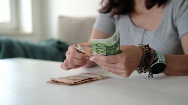 Girl Counts A Stack Of Euro Banknotes At Home
