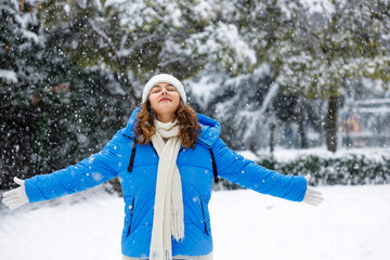 Young woman enjoying a snowy winter day