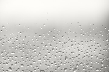 perfect backlit chaotic water drops on glass background. Natural hydration color of 2026 year cloud white