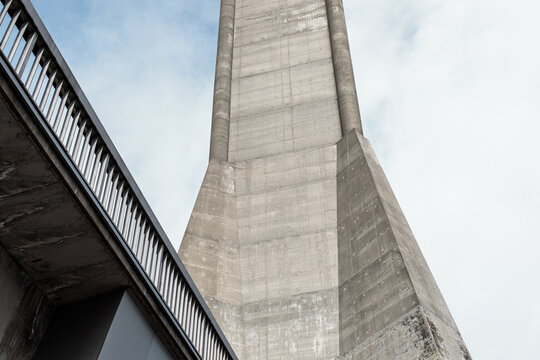 Low-angle abstract detail of the massive concrete base of the Avala tower against a cloudy sky, Belgrade, Serbia.