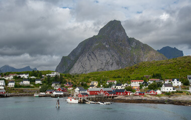 Reine fishing village with red rorbu cabins and fjord mountains