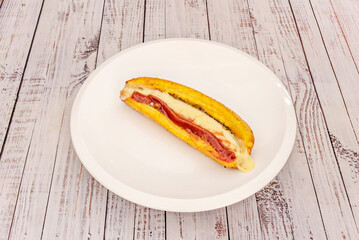 Traditional South American humitas with fresh corn paste, onion, basil, and cheese, wrapped in corn husks
