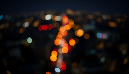 Colorful Christmas lights blur through the dark night street traffic in the city creating a bright bokeh glow