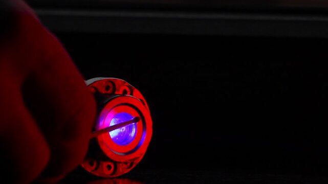 Powerful laser. Dangerous, powerful beam of laser light. Lighting a match.