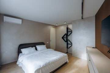designer bedroom with spiral staircase and textured walls