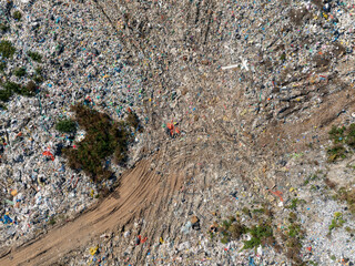 Aerial view of a landfill filled with large amounts of mixed household and plastic waste.