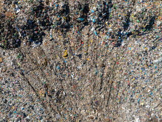 Aerial view of a landfill filled with large amounts of mixed household and plastic waste.
