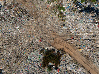 Aerial view of a landfill filled with large amounts of mixed household and plastic waste.