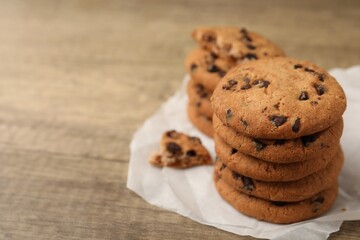 Delicious chocolate chip cookies on wooden table, closeup. Space for text