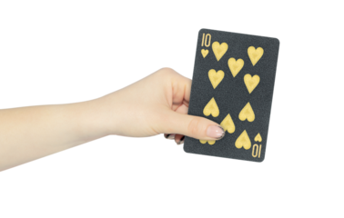 playing card hearts 10 in hand, outstretched hand with black playing card isolated from background