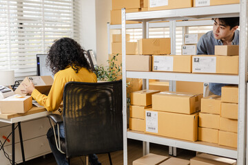 Small business warehouse worker inventory scanning and working process using tablet technology for stock updates, order control, parcel organization, shipping workflow in modern storage workpace