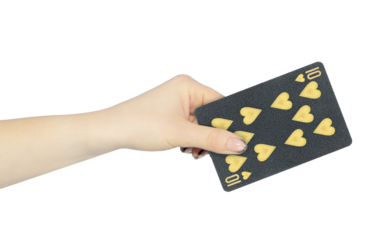 playing card hearts 10 in hand, outstretched hand with black playing card isolated from background