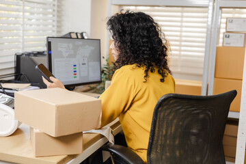 Small business warehouse worker inventory scanning and working process using tablet technology for stock updates, order control, parcel organization, shipping workflow in modern storage workpace