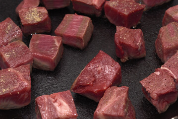 Lean beef being seared in a frying pan, cubed steak