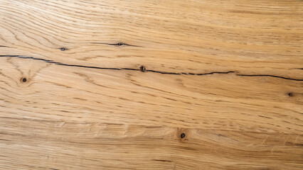 Close up of a light brown wooden surface with a crack running through it, showing the natural grain and texture of the wood