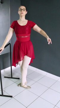 Ballerina performing tendu and rond de jambe &agrave; terre beside the barre. Vertical video great for dance tutorial, ballet tutorial, dance classes and beginner-level instruction.