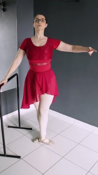Ballerina performing battement tendu jet&eacute; beside the barre. Vertical video great for dance tutorial, ballet tutorial, dance lessons on social media and beginner dancer training.