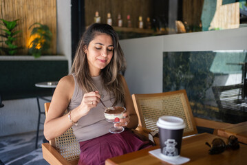 Woman Enjoying Dessert at Cafe