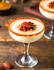 A glass of dessert with nuts on top