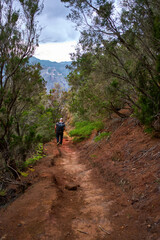 Fototapeta premium Man hiking downhill towards Afur village