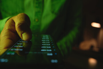 Hand holding smartphone displaying investment data and global stock exchange during night