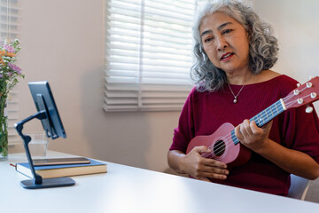 Senior Woman Using Tablet For learning Instrument