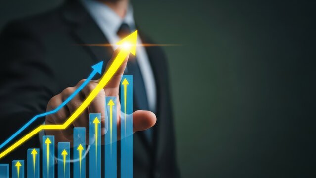 Businessman pointing at rising arrow and bar graph displaying financial growth
