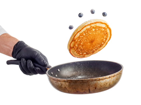 Chef hand flipping pancake frying pan isolated white background png transparent cutout breakfast cooking sweet dessert batter motion fluffy american food morning meal culinary skill action studio shot