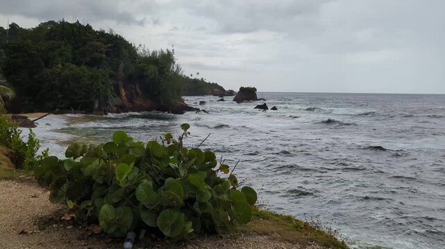 Sound of the sea beach located in Rampanalgas, Trinidad and Tobago. This ocean view or coastline photo was taken on a windy and overcast day.