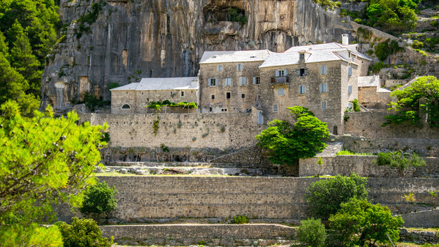 Croatia's Breč Island in Dalmatia. The beautiful and historic Blaca Monastery is surrounded by mountains above the Adriatic Sea.