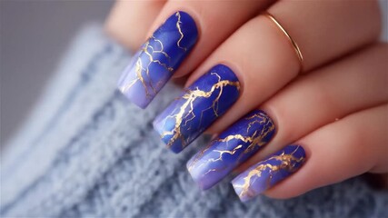 Stunning blue and gold nail art design showcasing unique lightning-inspired patterns for a chic look