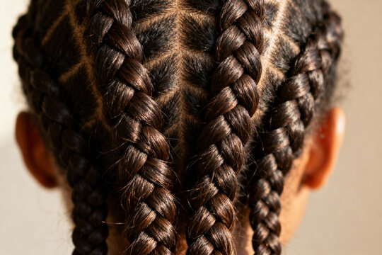Macro dark brown boxer cornrow braids on beige — Black protective hairstyle ad