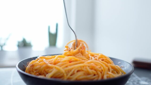 Close-up shot the fork picking delicious spaghetti