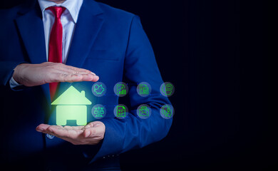 Businessman protecting a glowing house icon with insurance and finance symbols, representing home security, property protection, and financial safety.